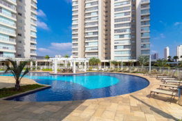 a pool in a courtyard with tall buildings in the background